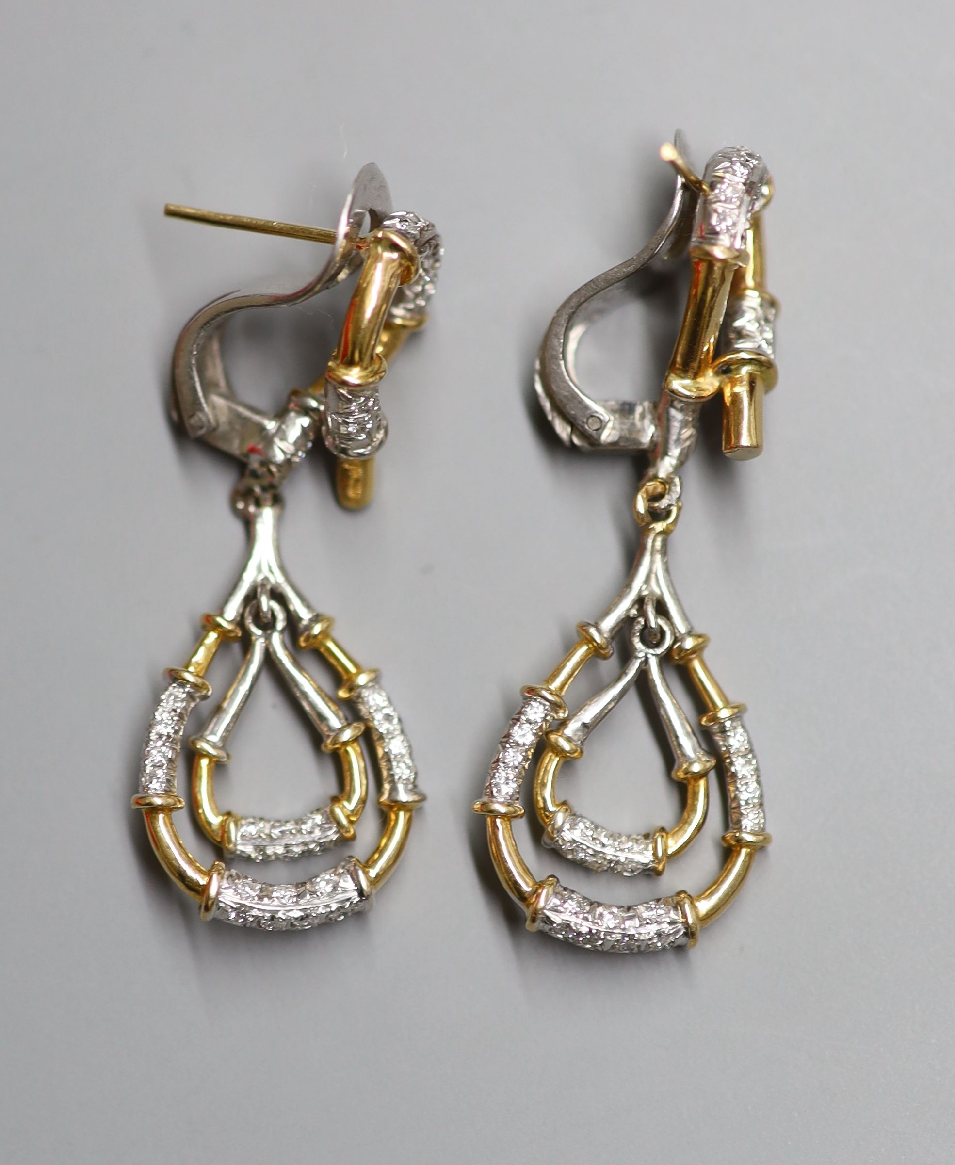 A modern pair of yellow and white metal, diamond chip set pear shaped graduated double drop earrings, 41mm, gross 11.3 grams.